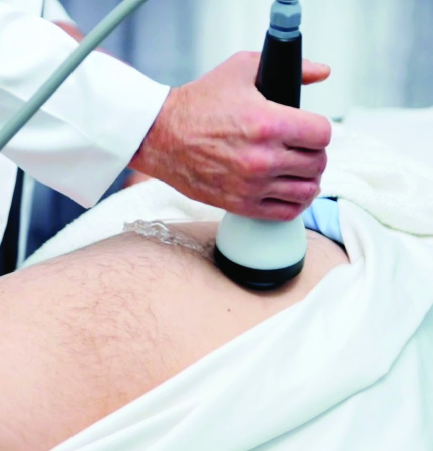 The StemWave applicator being held against the outside of a patient's hip